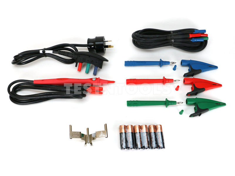 A multicolor multimeter test lead kit laid out on a white background, including a black power cord with a three-pin plug, black test leads, red and blue alligator clips, green and blue probes, a small metal terminal piece, and a row of six batteries. A semi-transparent 'TESTTOOLS' watermark is visible across the center.